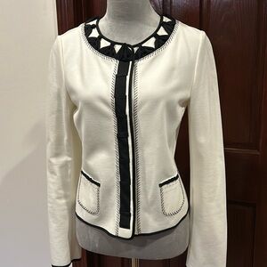 Short jersey jacket with outside pockets. Size small.